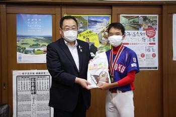 ユニフォームを着て首からメダルをかけているキャプテンの原野 泰成（はらの たいせい）さんがと市長と並んで写っている写真