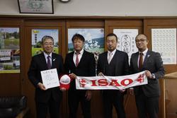 表敬に訪れたISAO選手（右から3人目）と関係者の方々が「ISAO」と書かれたタオルを広げて、高橋副市長と並んで写っている写真